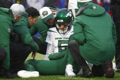 Jets quarterback Mike White receives assistance after taking a big hit against the Bills.