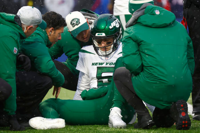 Jets quarterback Mike White receives assistance after taking a big hit against the Bills.