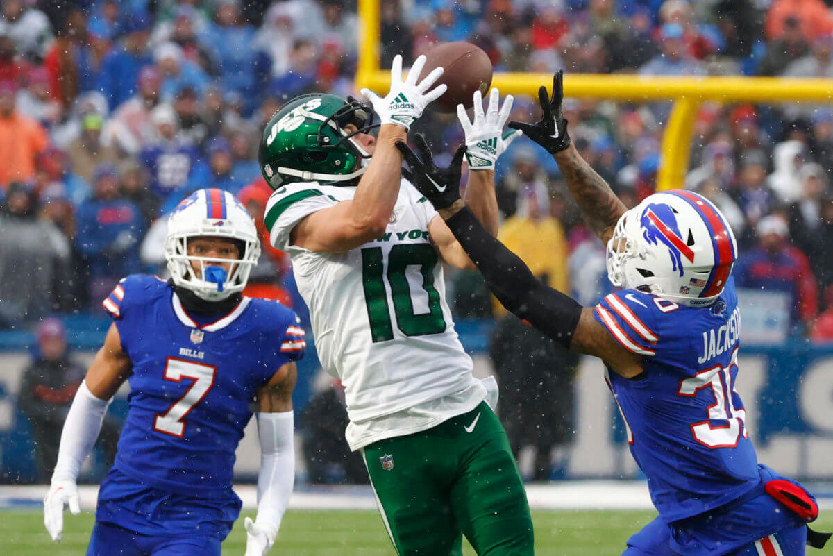 New York Jets wide receiver Braxton Berrios reaches for the ball under pressure from Buffalo Bills cornerback Taron Johnson.