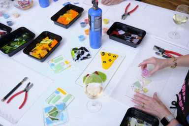 An overhead shot of a glass making class