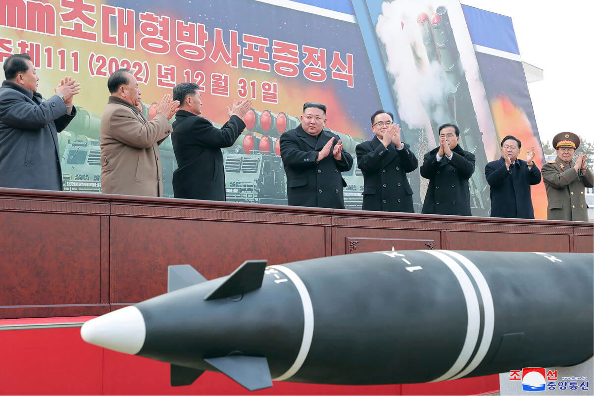 In this photo provided by the North Korea government, North Korean leader Kim Jong Un, center, attends a ceremony of donating 600mm super-large multiple launch rocket system at a garden of the Workers' Party of Korea headquarters in Pyongyang, North Korea.