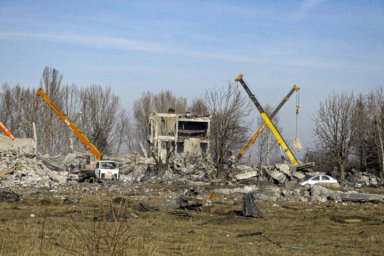 Workers clean rubbles after Ukrainian rocket strike in Makiivka, in Russian-controlled Donetsk region, eastern Ukraine.