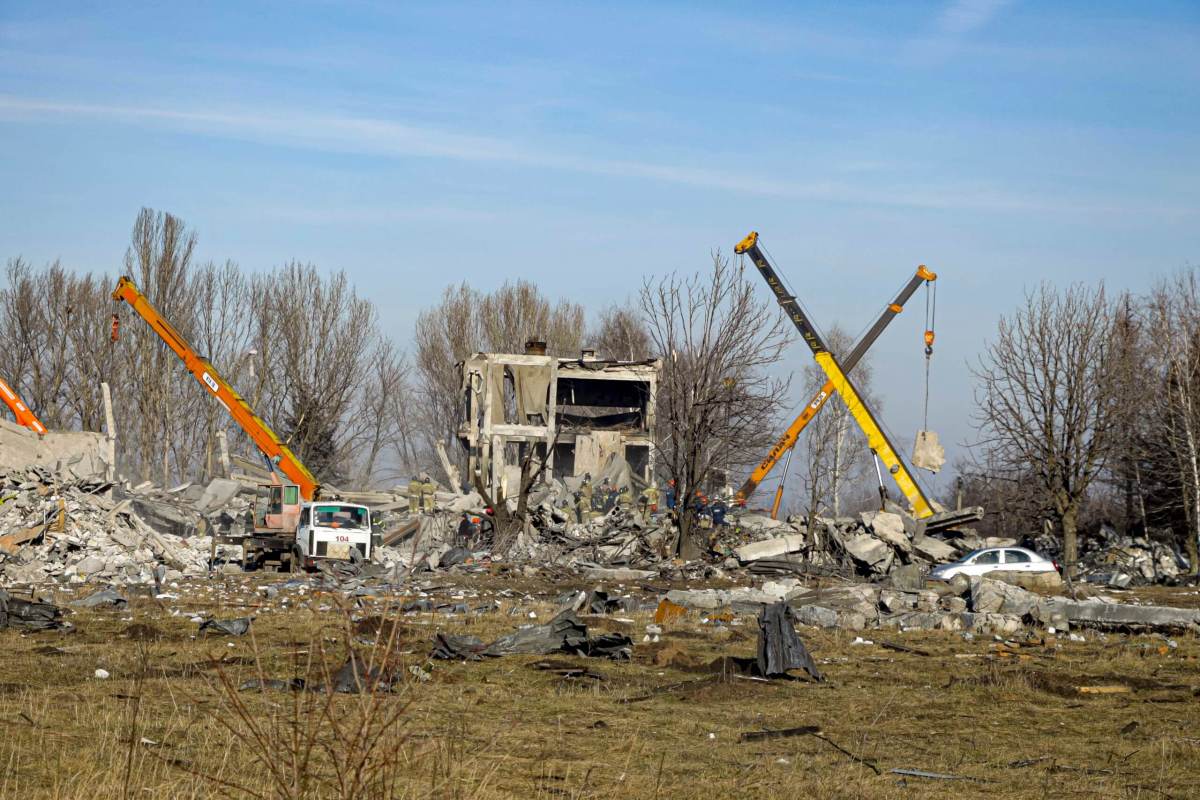 Workers clean rubbles after Ukrainian rocket strike in Makiivka, in Russian-controlled Donetsk region, eastern Ukraine.