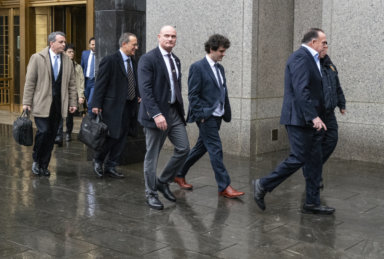 Cryptocurrency entrepreneur Sam Bankman-Fried, second from right, arrives for an appearance at Manhattan federal court Tuesday, Jan. 3, 2023, in New York. Bankman-Fried will be arraigned in a Manhattan federal court Tuesday on charges that he cheated investors and looted customer deposits on his cryptocurrency trading platform.