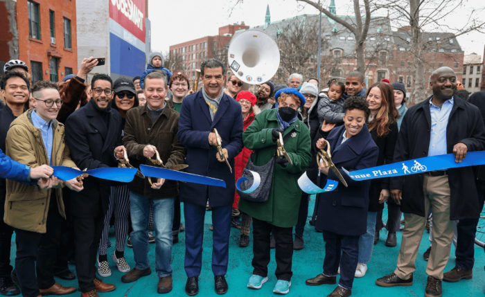 Officials gather to cut the ribbon on the new Underhill Plaza