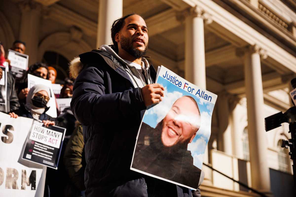 Man holds up photo of victim of police-involved shooting