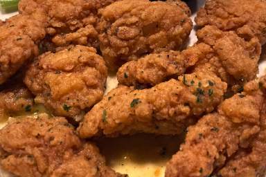 An order of "boneless chicken wings" rests on a plate,