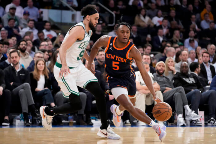 Immanuel Quickley of the Knicks scores against the Celtics