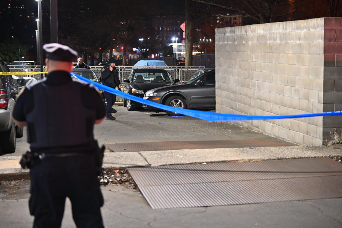 Officers from 71 Precinct investigate a shooting that left a woman hurt in a parking lot of the Ebbets Fields Houses on Saturday, 18.