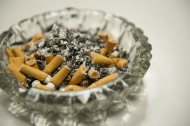 Ashtray full of ash and unlit cigarettes