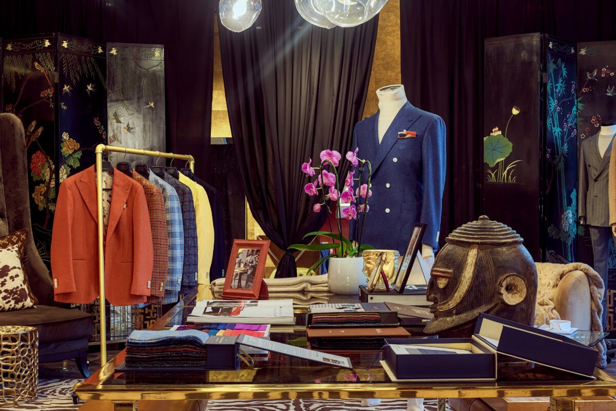 The interior of Sartoria Studio in Soho, featuring suits hanging up and custom decor.