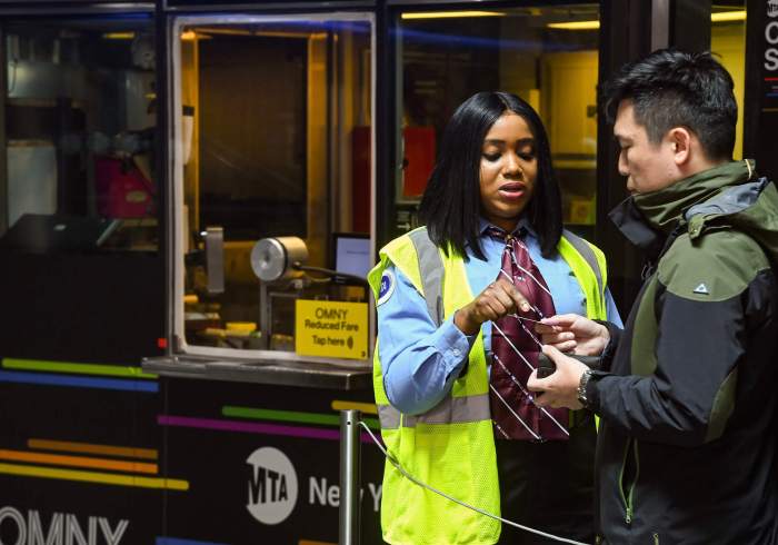 Subway station agents will no longer occupy token booths starting Thursday 3 A station agent talks to a rider at Fulton Center