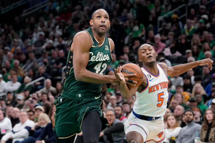 Al Horford drives on Immanuel Quickley of the Knicks