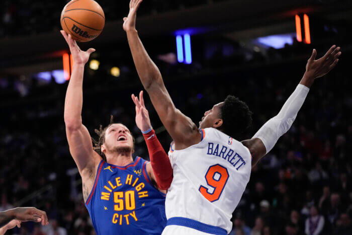 RJ Barrett of the Knicks defends Aaron Gordon