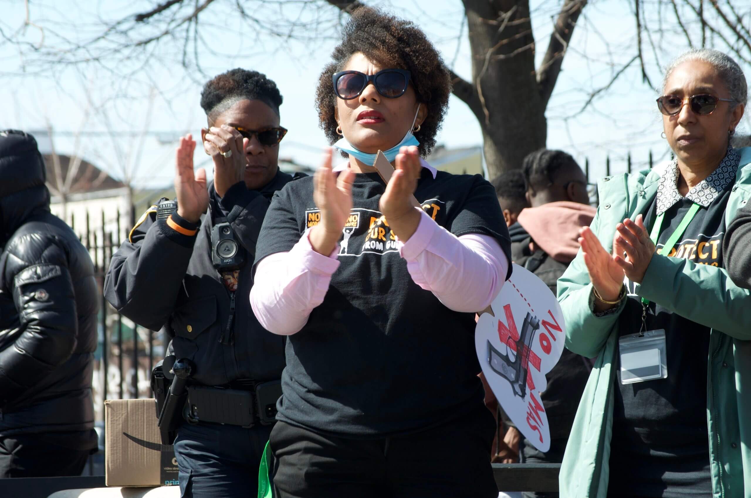 Educators, advocates, and NYPD officers on the day of a rally against gun violence