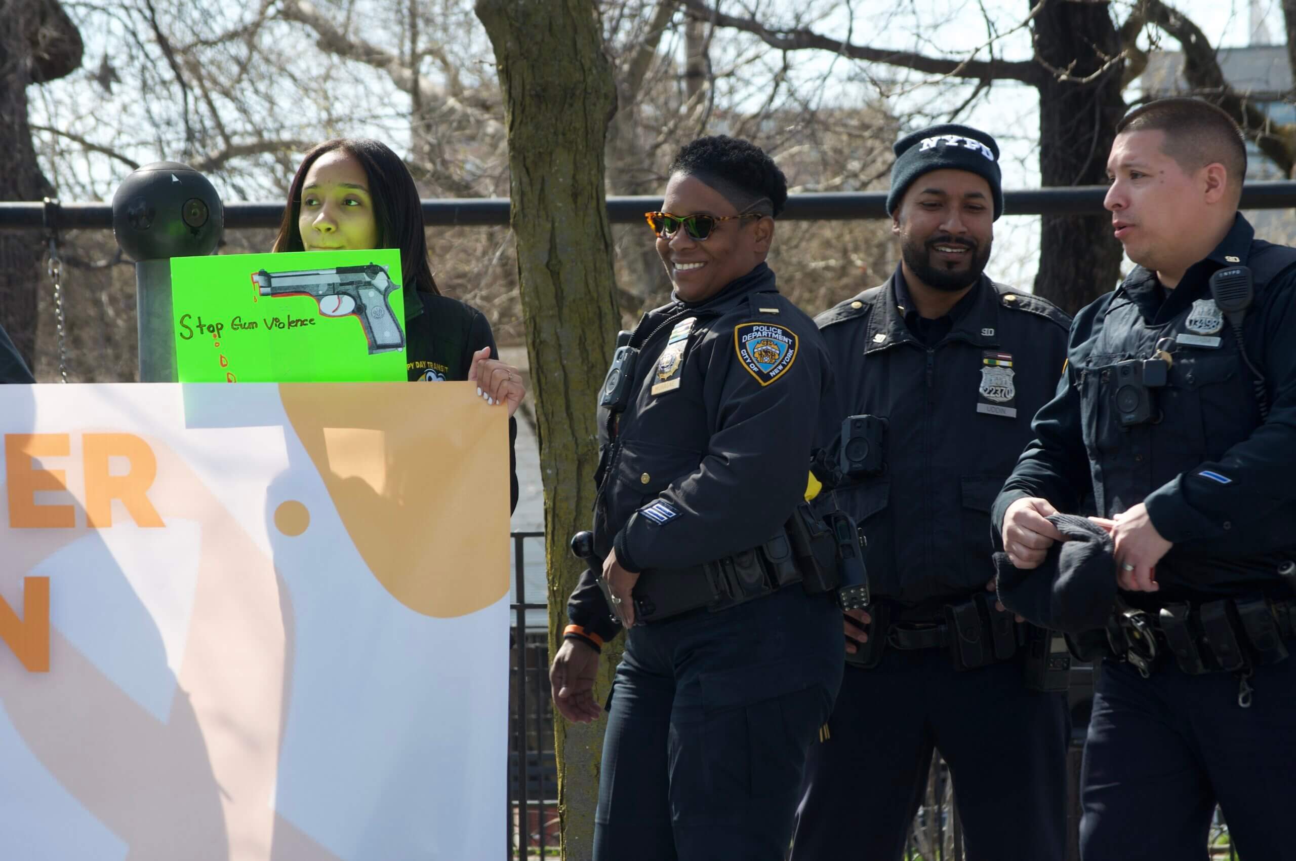 Educators, advocates, and NYPD officers on the day of a rally against gun violence