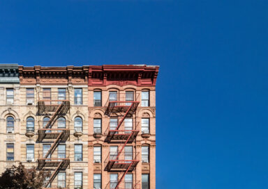 Blue sky above old building in NYC