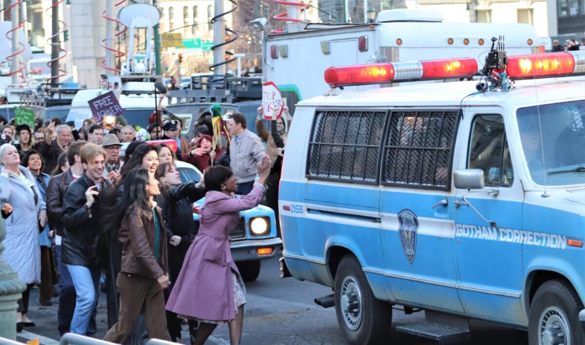 Crowds descend on a police van holding the Joker, on the set of Joker 2, "Joker: Folie à Deux" (Photo by Michael Dorgan)