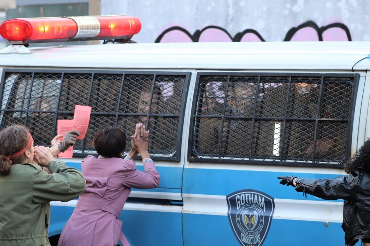 Crowds descend on a police van holding the Joker, on the set of Joker 2, "Joker: Folie à Deux" (Photo by Michael Dorgan)