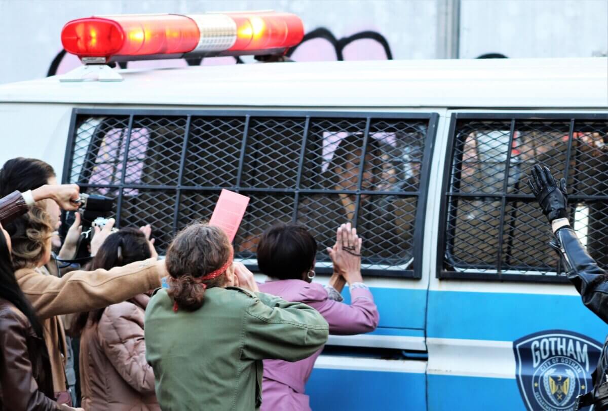 Crowds descend on a police van holding the Joker, on the set of Joker 2, "Joker: Folie à Deux" (Photo by Michael Dorgan)