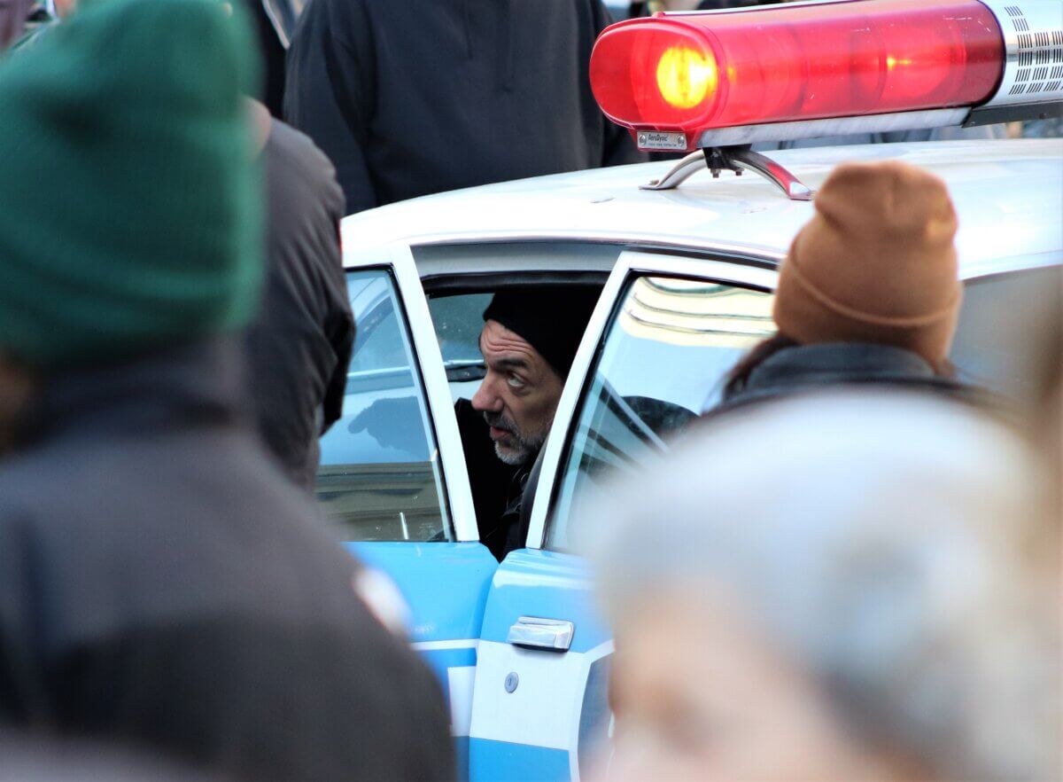 Director Todd Philips inside a police car on the set of Joker 2, "Joker: Folie à Deux." Photo by Michael Dorgan)