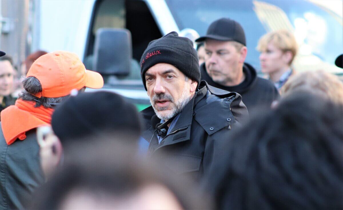 Director Todd Philips on the set of Joker 2, "Joker: Folie à Deux." Philips is wearing a joker movie-branded hat (Photo by Michael Dorgan)