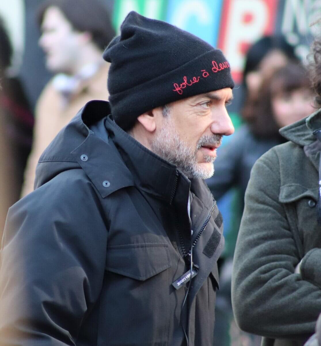 Director Todd Philips on the set of Joker 2, "Joker: Folie à Deux." Philips is wearing a joker movie-branded hat (Photo by Michael Dorgan)