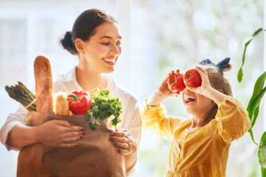 Mother and daughter holding shopping bag