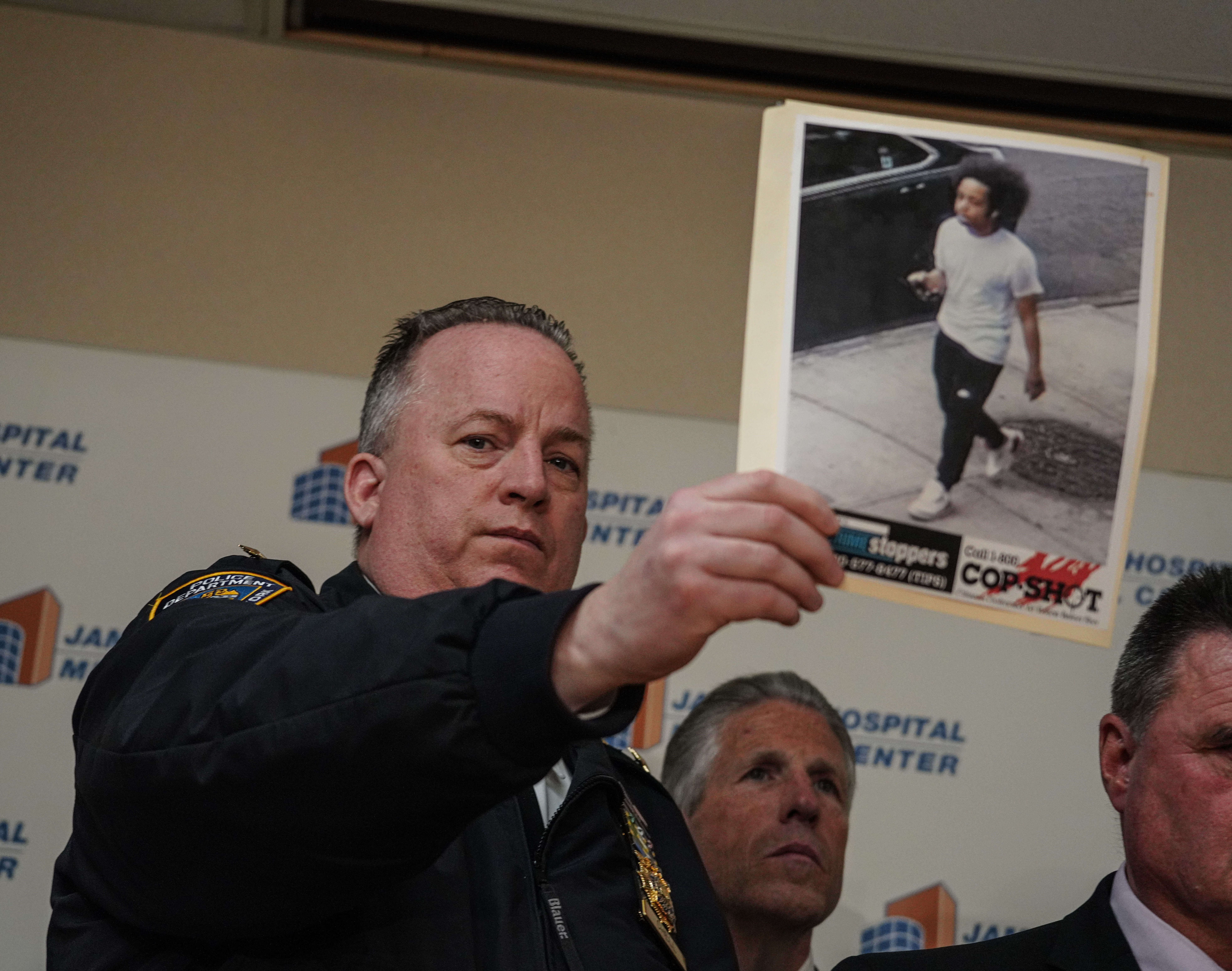Chief of Patrol John Chell holds up a picture of the shooting suspect
