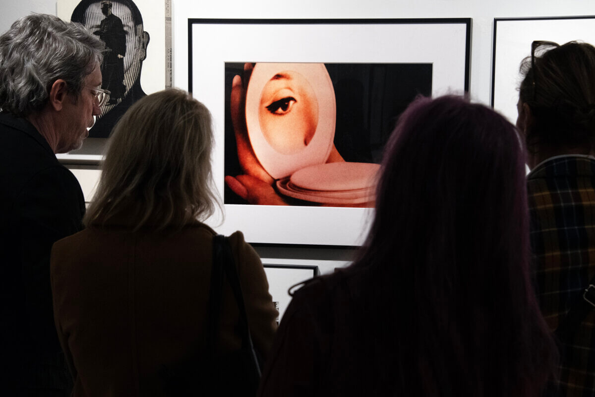 Viewers check out photo of eyeball on display at AIPAD show in Midtown