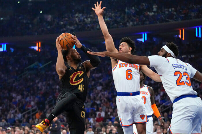 Knicks Quentin Grimes challenges a Donovan Mitchell shot
