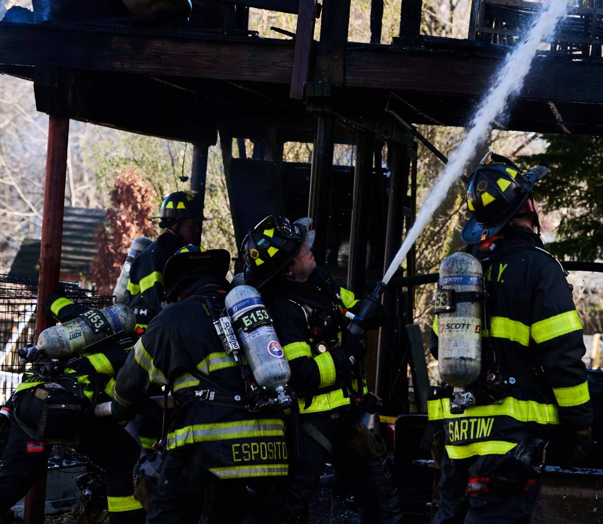 Firefighters work a hose-line to knock down heavy fire in the attic of a two-story home in Staten Island