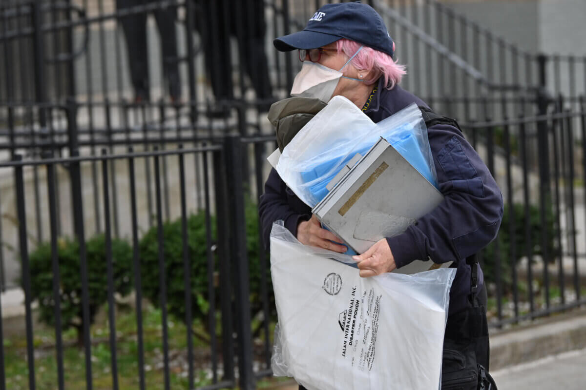 An official with the city's Medical Examiner's office arrives at the scene of a fatal stabbing at Wyckoff Gardens