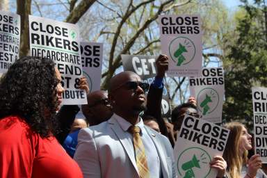 Council Members Kevin Riley (center) and Carmen De La Rosa (left) at rally to close Rikers Island in City Hall Park, which a new commission will study.