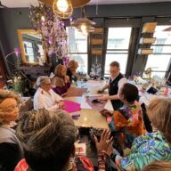 Anthony Luciano (back center) teaches a Sip & Stitch class in New York City.