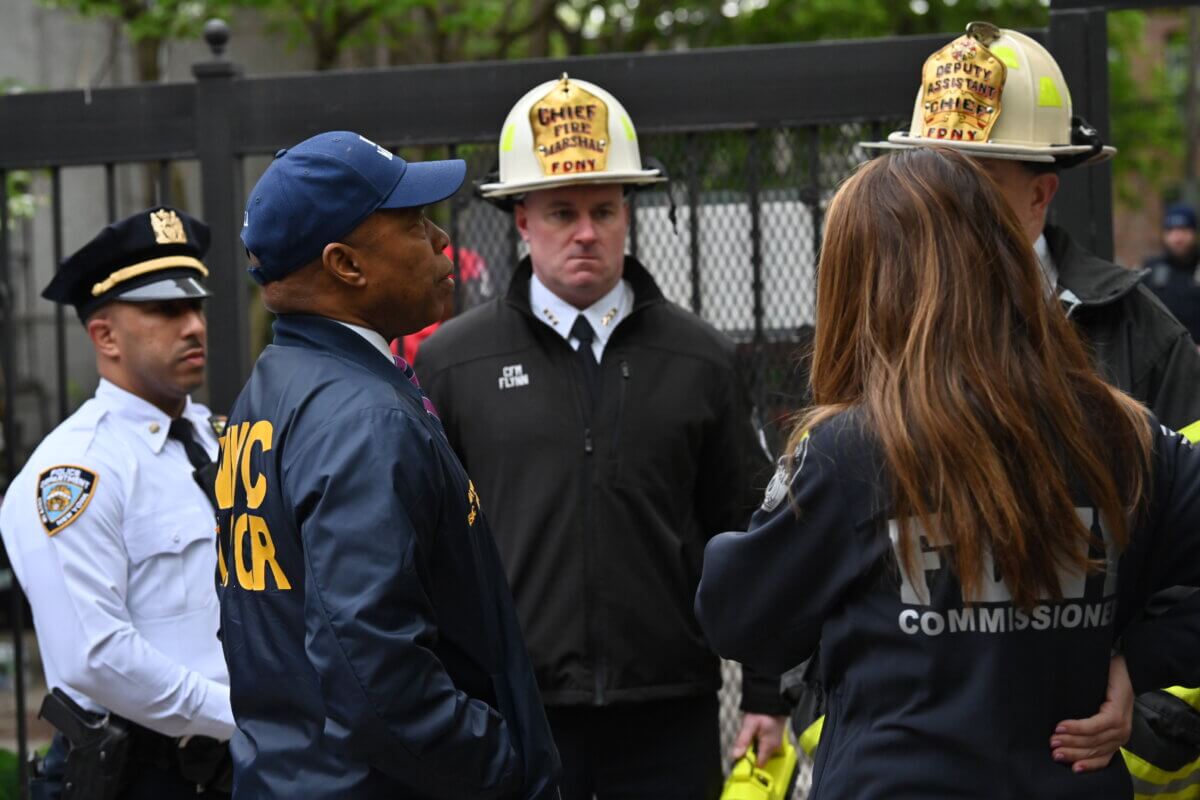 Mayor Eric Adams and Fire Commissioner Laura Kavanagh speak with FDNY officials