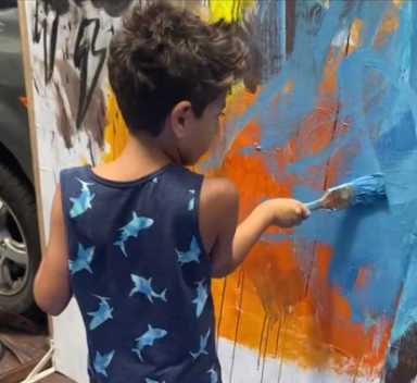 Young-student-paints-during-Foundation-for-New-American-Arts-Paint-Brushes-Not-Guns-Festival-at-The-Clemente-Cultural-and-Educational-Center-e1680724882594