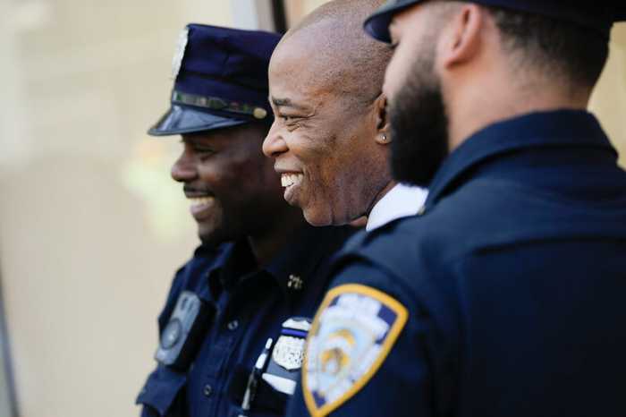 Mayor Eric Adams (center) standing with two police officers. Wednesday, May 17, 2023.