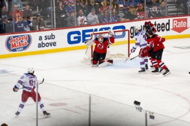 Devils goaltender Akira Schmid makes a glove save on Rangers forward Mika Zibanejad during the first period of Game 7 at Prudential Center in Newark on May 1, 2023.