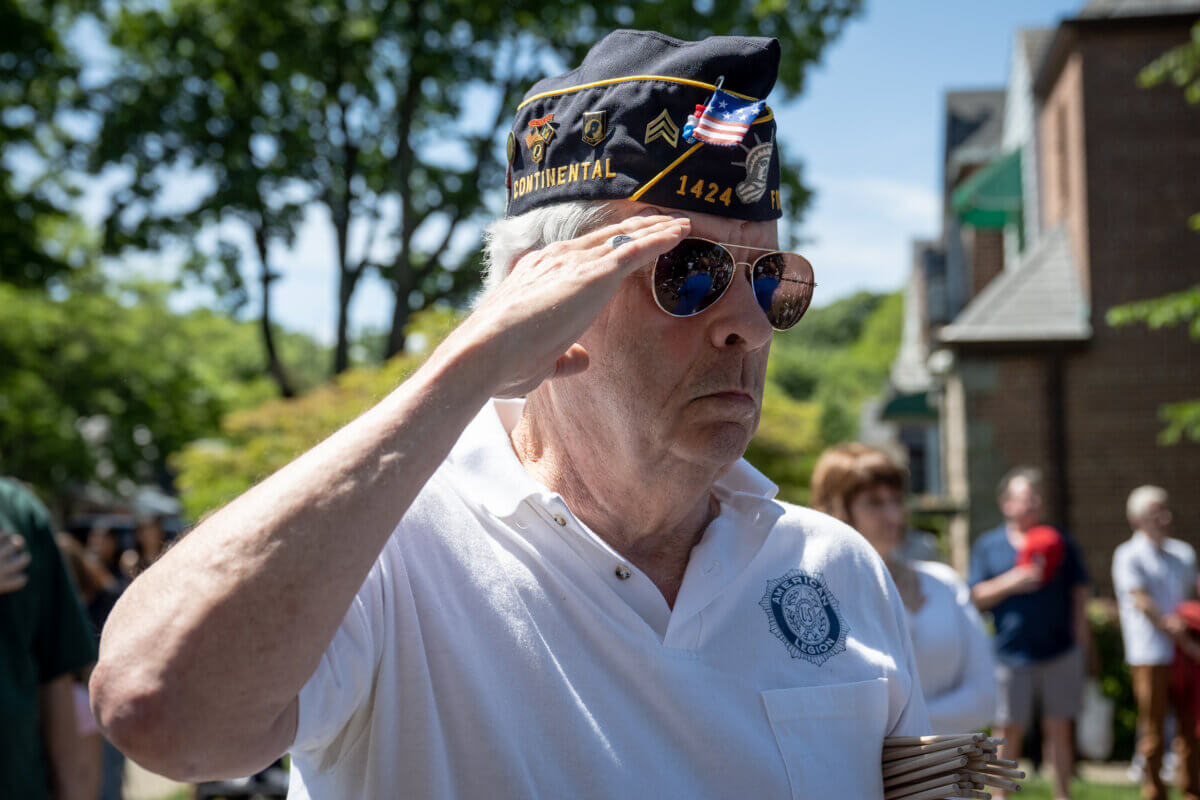 U.S. Veterans stand in salute during the rendition of the American Anthem