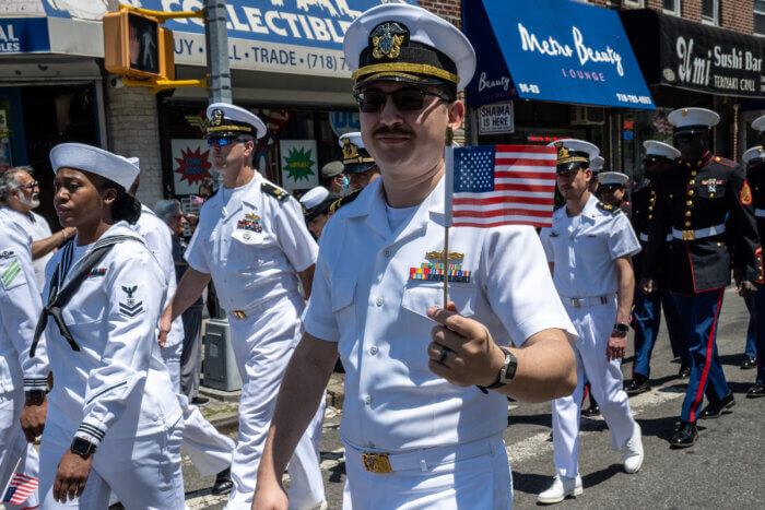 Memorial Day parade in Queens features U.S. Navy members proudly waving the American flag