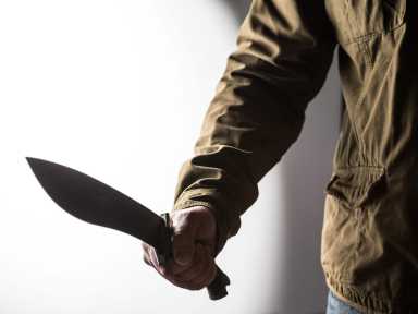 A man with a machete menaced a group of teens outside a Staten Island high school Tuesday morning.