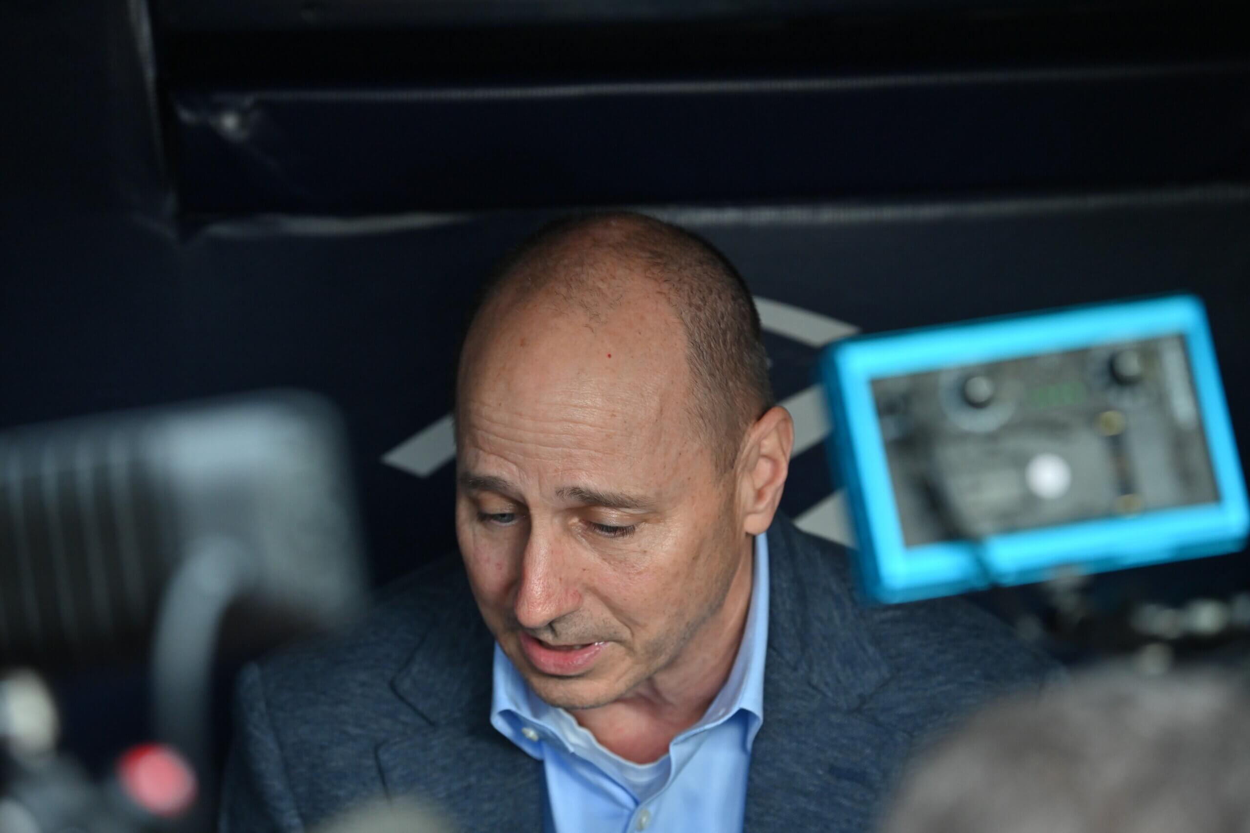 Yankees general manager Brian Cashman speaking to reporters inside the dugout at Yankee Stadium on May 3, 2023.