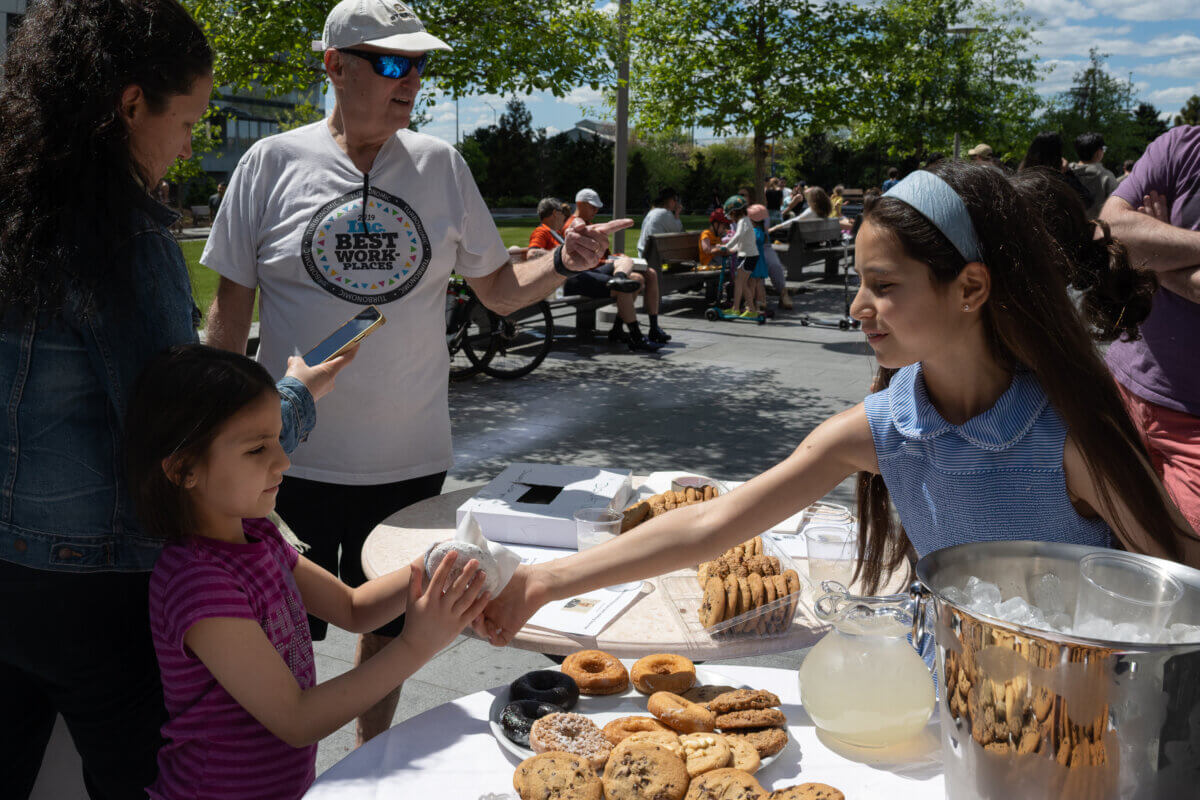 Acts of Kindness | 11-year-old raises funds to replace Lincoln Square doorman's stolen motorcycle 7 Dylan Leder hands a donut to a young girl