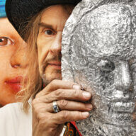 Artist Walter Steding with a mask he created
