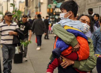 Child with mask during poor air quality and smoke filled skies in Queens
