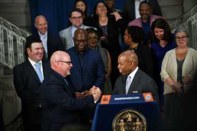 Mayor Eric Adams and UFT President Michael Mulgrew shake hands on 5-plus year labor deal reached between the city and teacher's union.