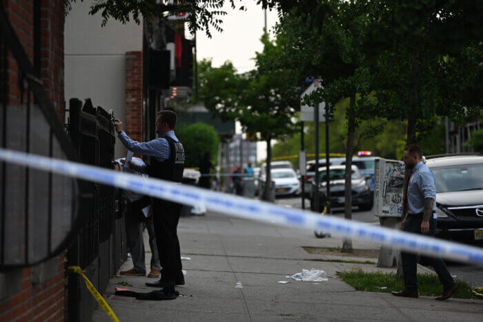 olice at the crime scene where a 16-year-old boy was gunned down in Brooklyn Monday
