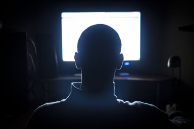 Young Adult Man in Front of Computer Monitor