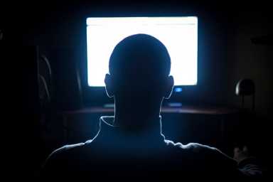 Young Adult Man in Front of Computer Monitor